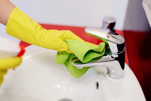 Office cleaning team disinfecting shared surfaces in a SW12 workplace