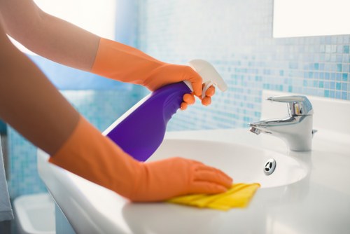 Technician applying safe cleaning procedures with protective equipment