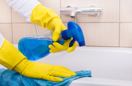 Cleaner arranging supplies for house cleaning in SW12